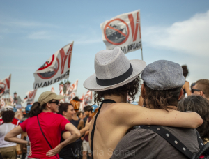 Two lovers hugging in front of protesters against cruise ships in Venice