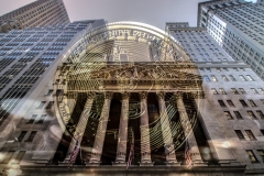 Bitcoin with wall street stock exchange facade on background