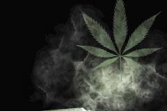 Cannabis joint creating a marijuana leaf of smoke