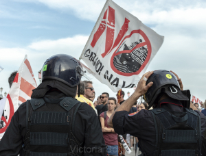Two carabinieri in front of protesters against cruise ships in Venice