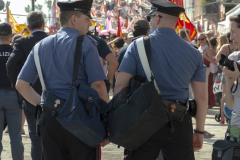 Two carabinieri in front of protesters against cruise ships in Venice